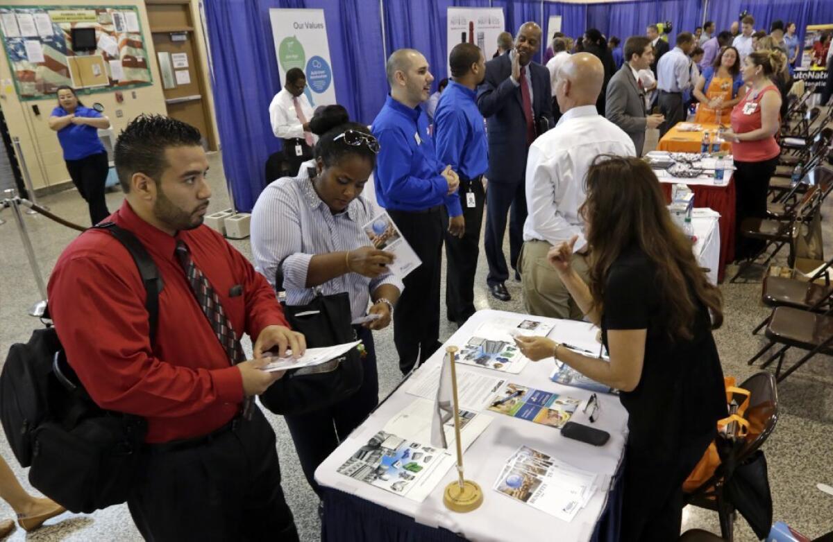 Workers check out opportunities at a recent job fair in Florida.
