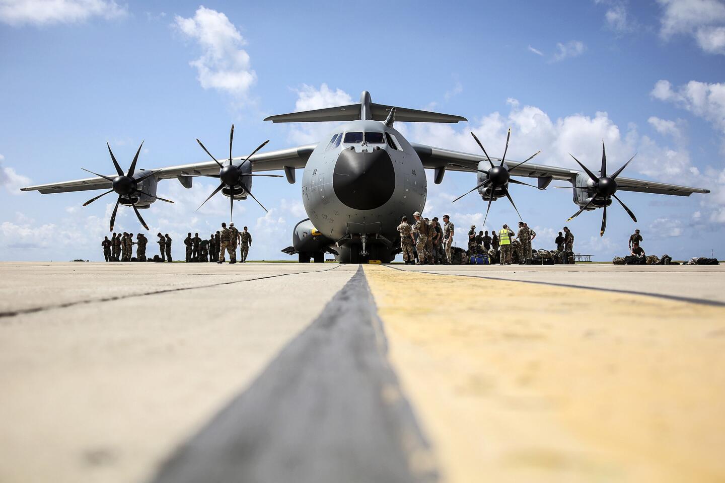 A handout picture released by the British Ministry of Defence (MOD) on Sept. 10, 2017, shows Royal Marine Commandos from 40 Commando preparing to board an RAF A400M in Barbados on Sept. 9, 2017, to fly to the British Virgin Islands to provide disaster relief after Hurricane Irma.