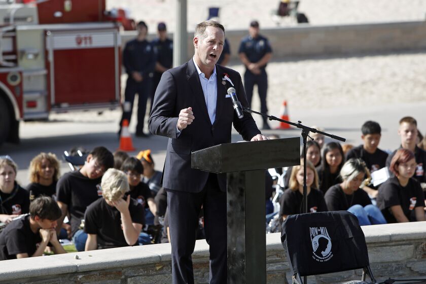 Rep. Harley Rouda (D-Laguna Beach) speaks during a Veterans Day ceremony at Pier Plaza in Huntington Beach on Monday.