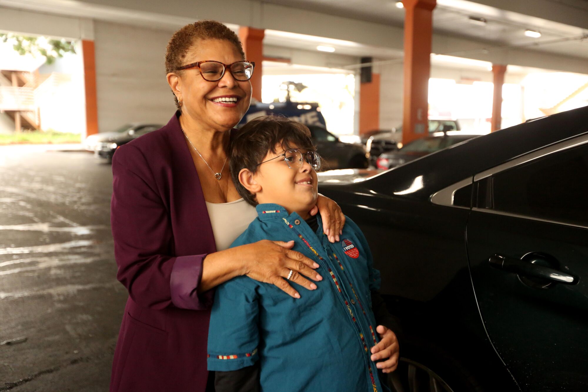 Los Angeles mayoral candidate Rep. Karen Bass, with her grandson Henry, 8, votes at the Baldwin Hills Crenshaw Center 