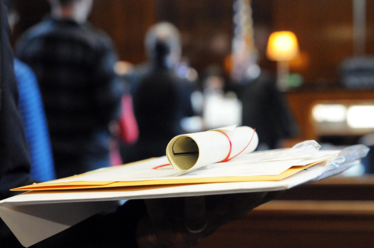 A certificate of citizenship rests atop other paperwork at the Joel W. Solomon Federal Building in Chattanooga, Tenn. on Thursday, Oct. 16, 2014. Nearly 100 people became naturalized United States citizens at a ceremony there.