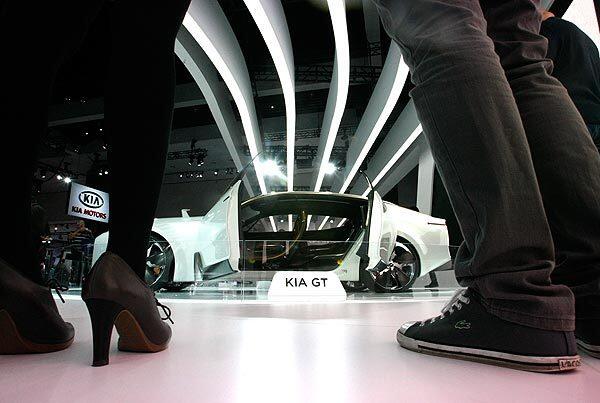 Young visitors look at the Kia GT at the L.A. Auto Show.