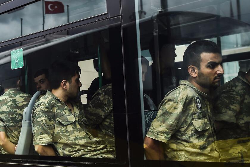 Detained Turkish soldiers accused of taking part in an attempted military coup arrive in a bus at the courthouse in Istanbul on Wednesday.