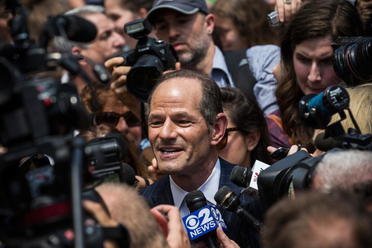 Former New York Gov. Eliot Spitzer is mobbed by reporters as he attempts to collect signatures to run for comptroller of New York City.