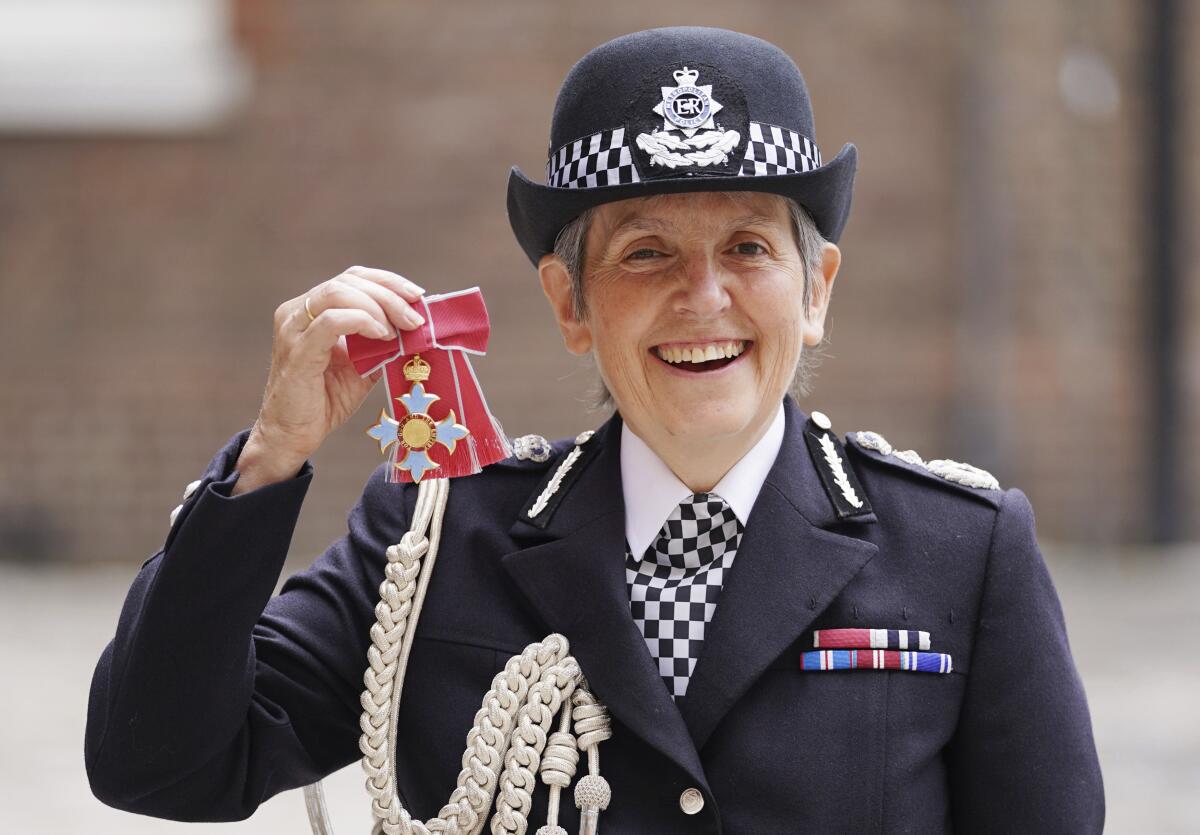 FILE - In this Wednesday July 14, 2021 file photo, Britain's Metropolitan Police Commissioner Cressida Dick poses for her photo after she was made a Dame Commander of the Order of the British Empire, at St James's Palace in central London. The British government on Friday, Sept, 10 says the country's most senior police officer will stay in her job for another two years. Metropolitan Police Commissioner Cressida Dick will remain at the helm of the London force until April 2024. (Kirsty O'Connor/Pool Photo via AP, file)