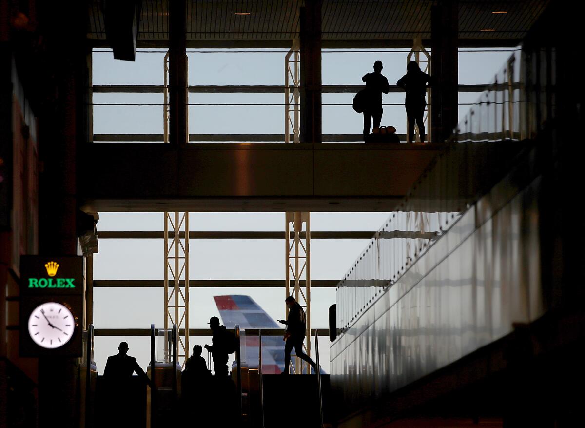 A plane tail is seen through a window at Los Angeles International Airport.