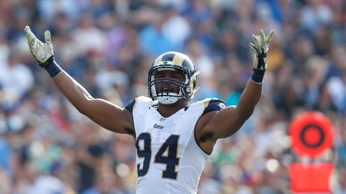 Rams defensive end Robert Quinn gestures to the crowd during a game against the Carolina Panthers at the Coliseum on Nov. 6.