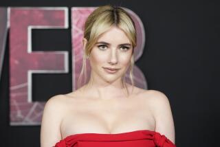Emma Roberts in red off-shoulder gown at the Feb. 2024 premiere of "Madame Web" at the Regency Village Theatre in Los Angeles