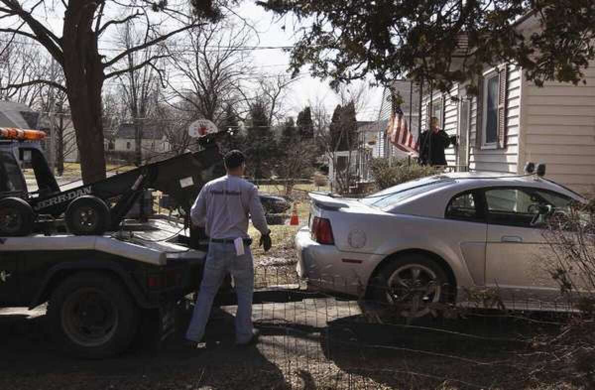 Jeff Grevelding prepares to tow a vehicle in Syracuse, N.Y., last year after its owner allegedly fell behind in loan payments.