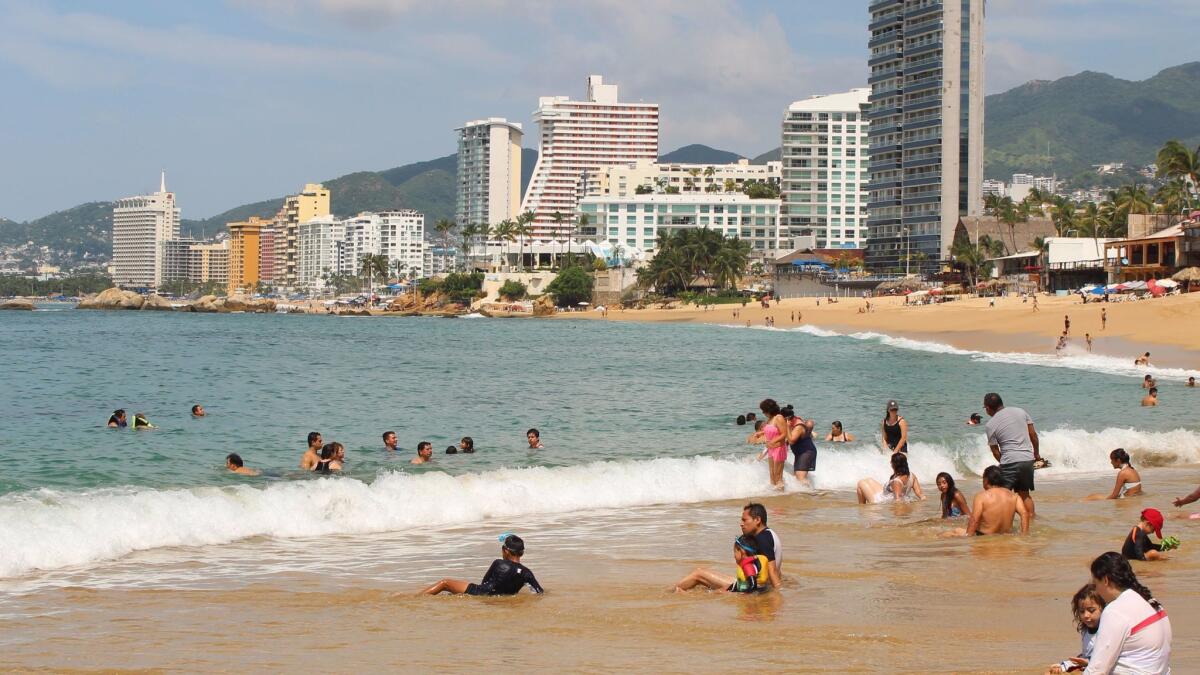 Beachgoers enjoy the water and sand in Acapulco, Mexico. Mexico was the most popular destination in 2015 for Americans traveling abroad.