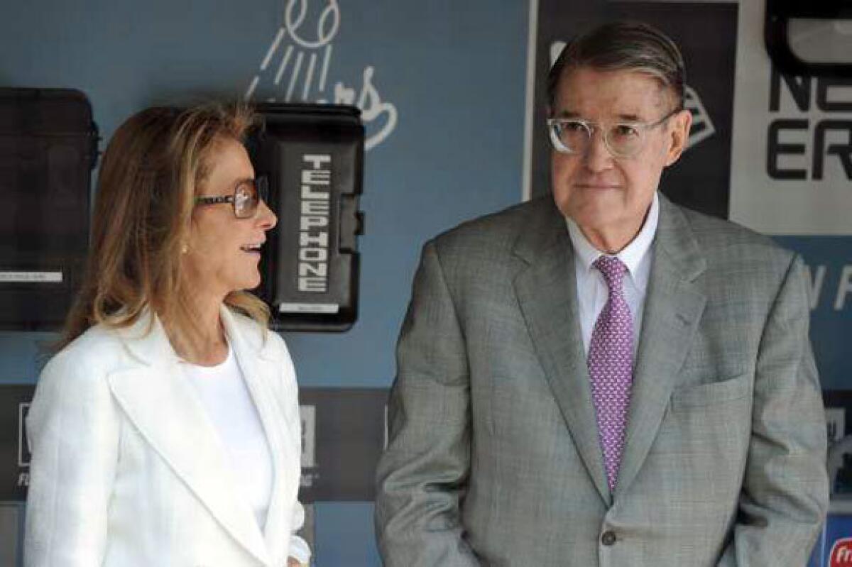 Peter O'Malley and his wife, Annette, stand in the Dodger dugout prior to this season's home opener.