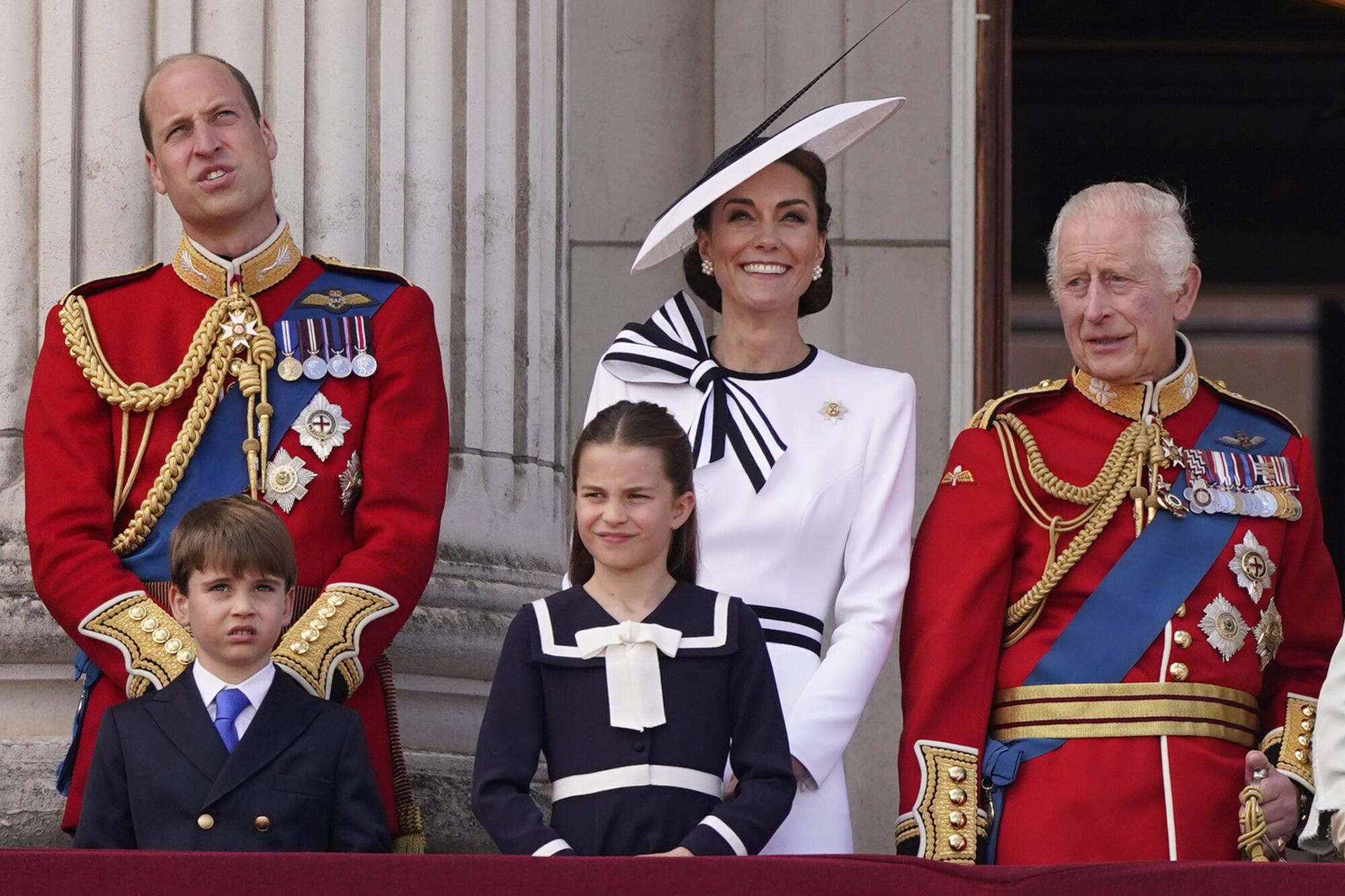 Prince William and Kate Middleton with their two children and King Charles.