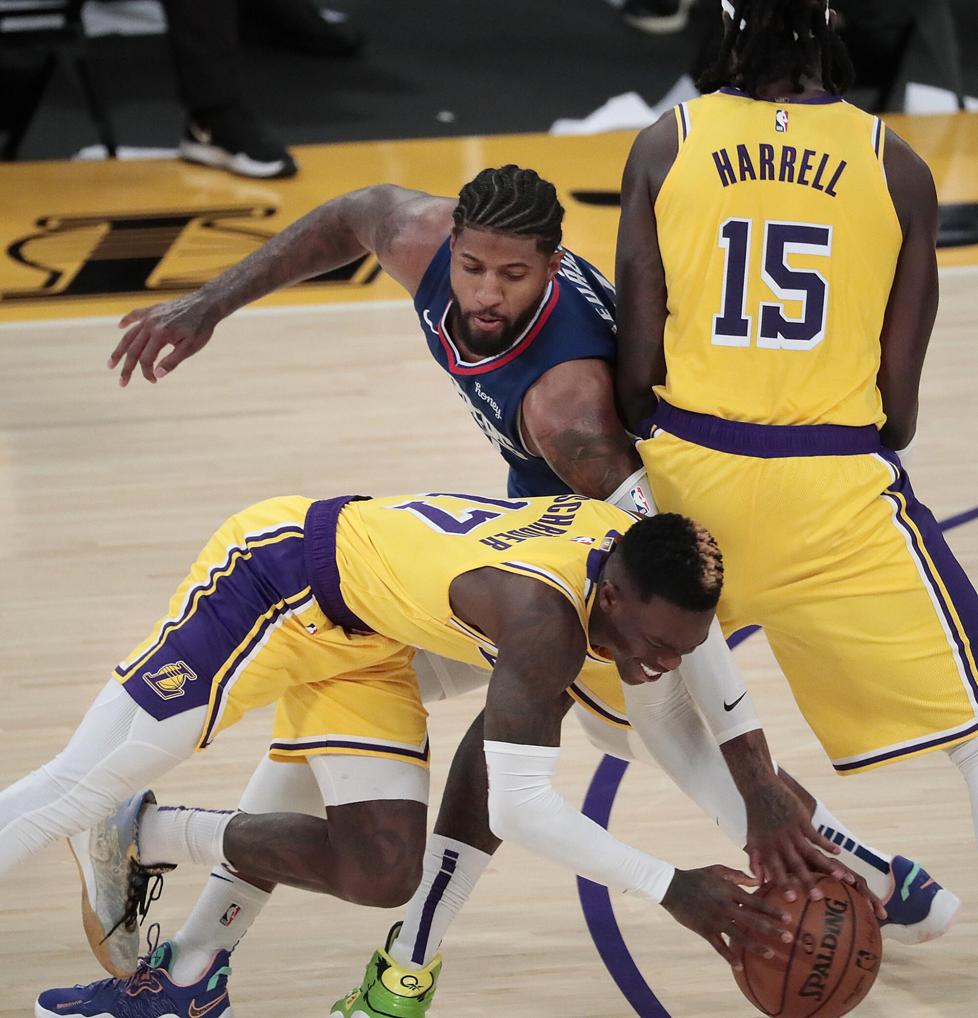 Lakers guard Dennis Schroder stumbles while being defended by Clippers forward Kawhi Leonard during the second half.