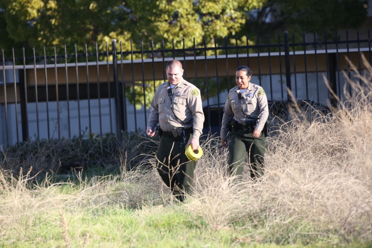 L.A. County sheriff's deputies secure an open are during the search for a missing 3-week-old girl in Newhall.