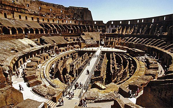 The Colosseum is one of Rome's most visited ancient landmarks. (The wooden walkway in the center is a modern addition.) At the site, costumed gladiators pose for pictures, and tourists can experience a new way of touring the Colosseum, called the Time Machine, which uses hand-held video monitors showing digitalized images of what the arena looked like in ancient times.