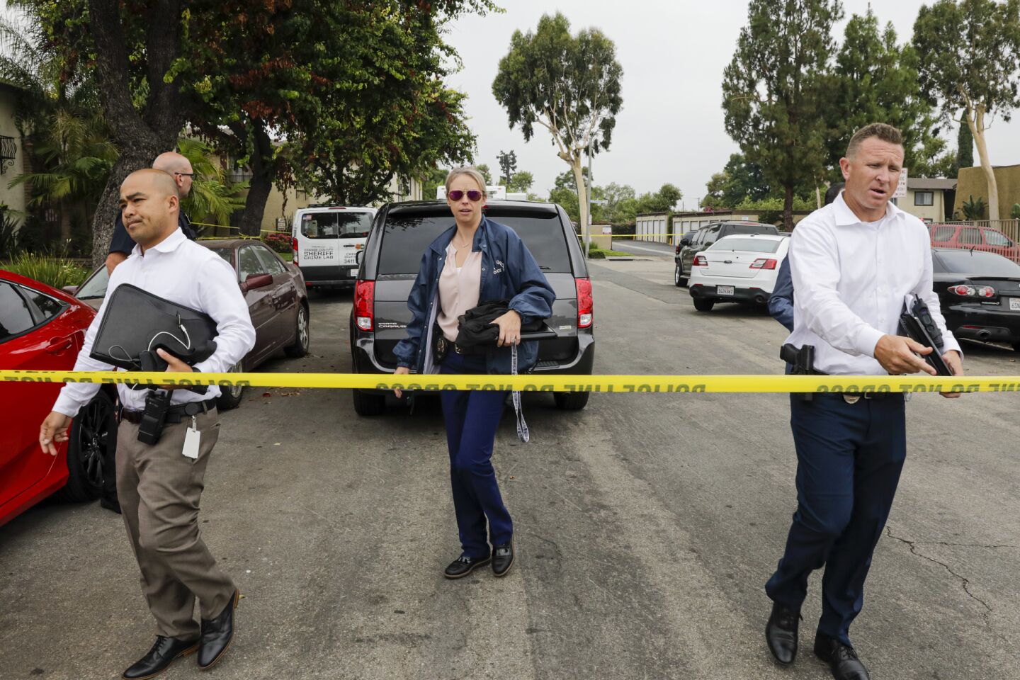 Police investigators work at the Casa De Portola apartment complex in Garden Grove where the first two victims in a stabbing rampage were attacked Wednesday.