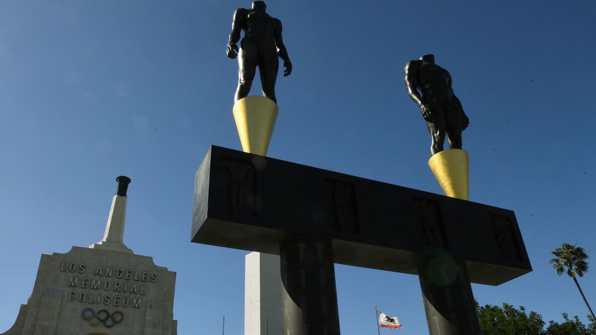An Olympic-themed monument stands outside Los Angeles Memorial Coliseum.
