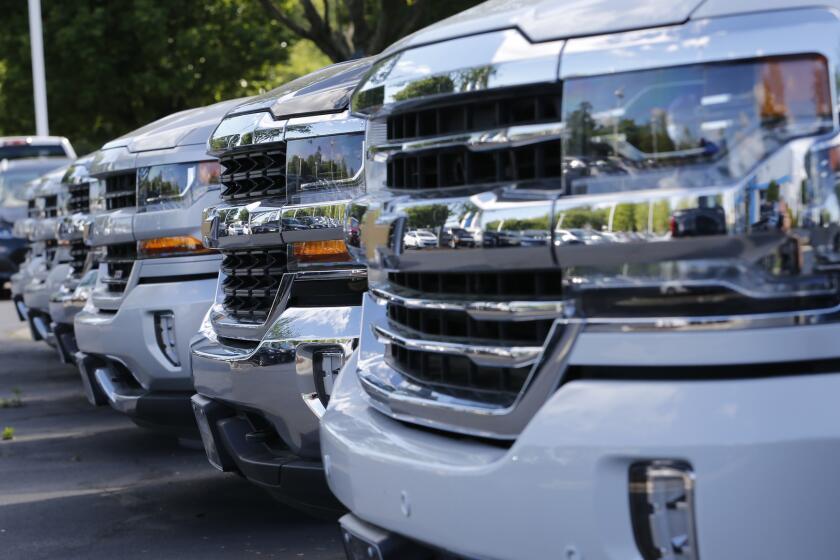 In this Wednesday, April 26, 2017, photo, trucks are lined up in the lot at a dealership in Richmond, Va. Consumers cut back on their shopping in August by the largest amount in six months as a big drop in auto sales offset gains in other areas, according to information released Friday, Sept. 15, 2017, by the Commerce Department. (AP Photo/Steve Helber)