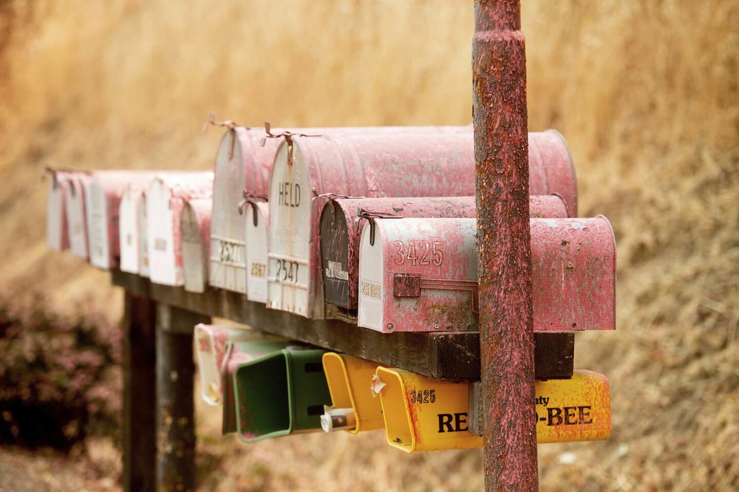 Fire retardant covers mailboxes in Lakeport, Calif., as crews work to contain the Mendocino Complex Fire on Wednesday, Aug. 8, 2018. Firefighters said Wednesday that they have made good progress battling the state's largest-ever wildfire but didn't expect to have it fully under control until September.