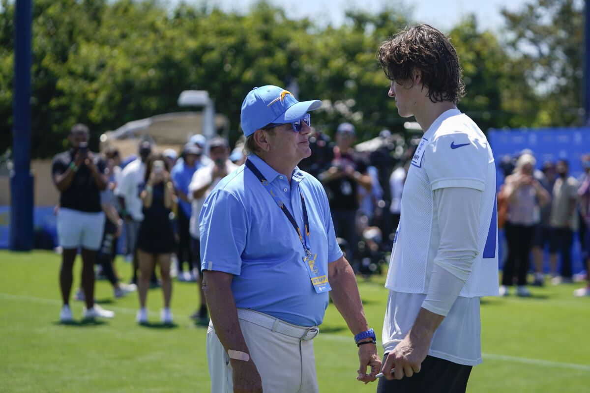 Chargers owner Dean Spanos speaks with quarterback Justin Herbert during camp Wednesday.