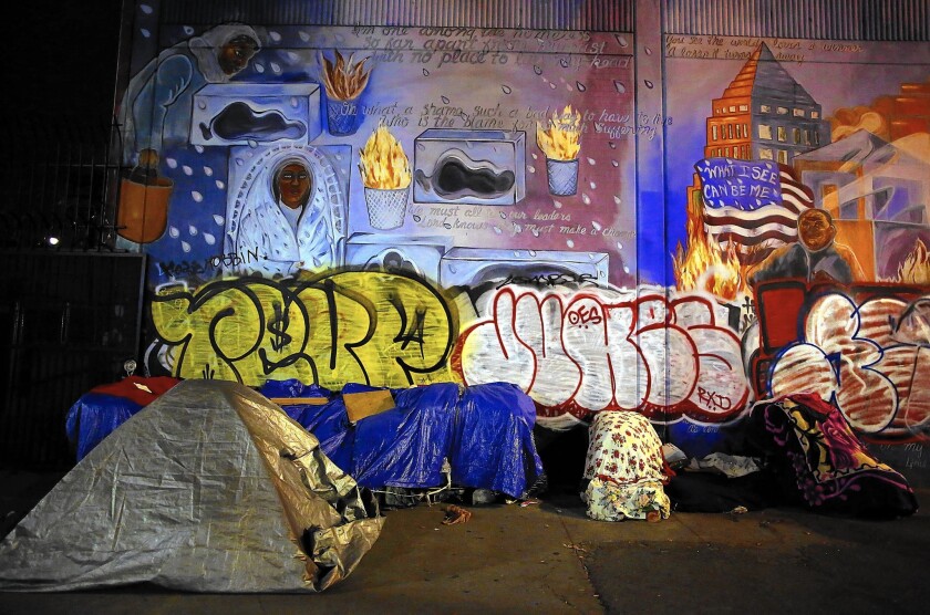 Homeless people sleep in tents along Los Angeles' skid row in January.