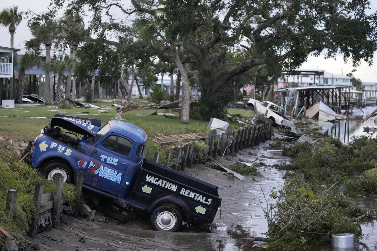 Trucks and debris sit in a canal