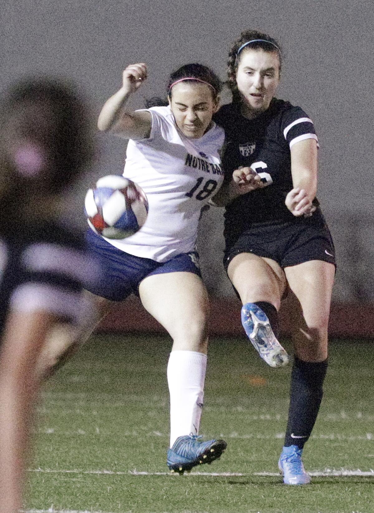 Sherman Oaks Notre Dame's Ashley Effatian leans into Flintridge Sacred Heart defender Allison Risha who clears the ball in a Mission League girls' soccer game at Occidental College in Los Angeles on Wednesday, January 8, 2020.