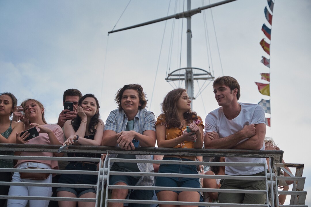 Group of teens standing on railing