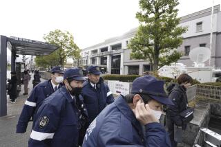 Police officers gather outside the Kyoto District Court in Kyoto, western Japan, Thursday, Jan. 25, 2024, ahead of the sentencing hearing for Shinji Aoba, who has confessed to a deadly arson attack in July 2019 on a Kyoto Animation Co. studio. Aoba was convicted of murder and other crimes Thursday for carrying out the shocking arson attack on the anime studio that killed 36 people and drew an outpouring of grief from anime fans worldwide. (Miki Matsuzaki/Kyodo News via AP)