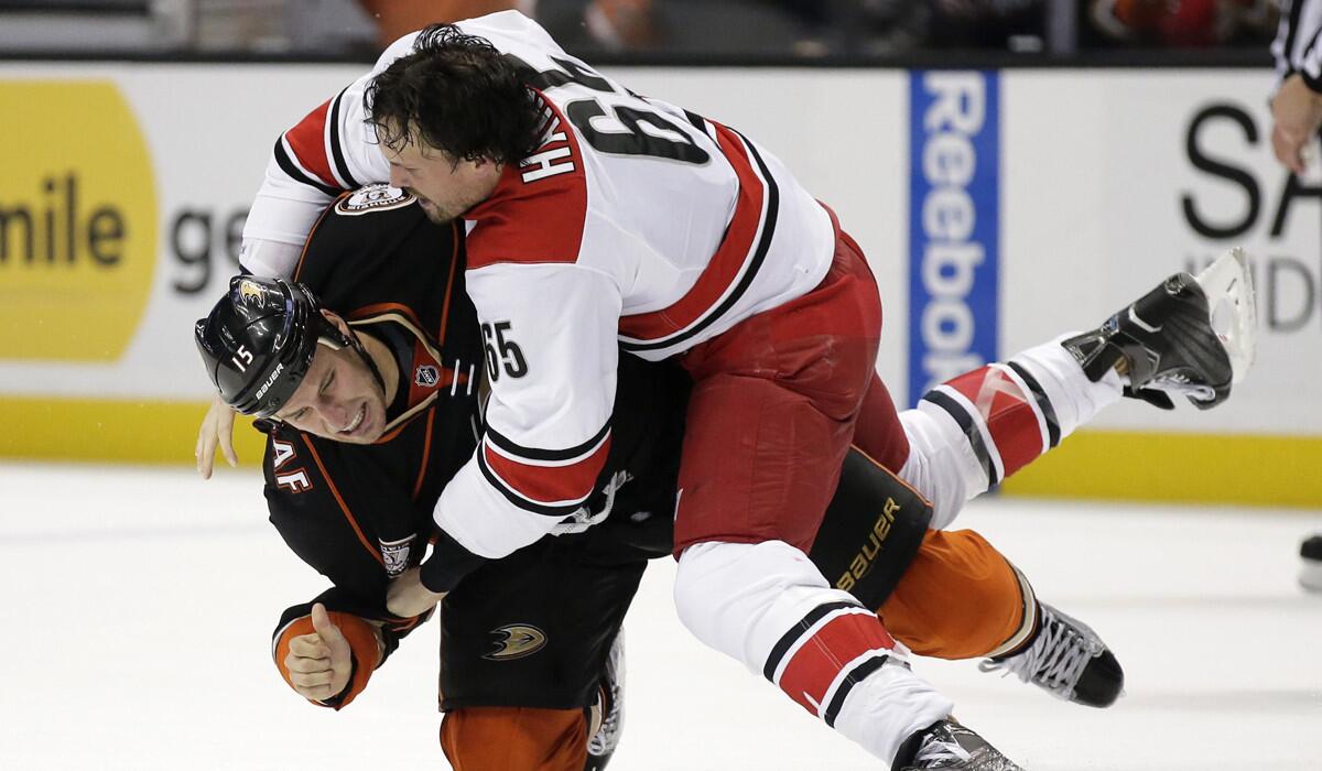 Carolina Hurricanes defenseman Ron Hainsey brawls with Anaheim Ducks center Ryan Getzlaf during the second period on Friday.