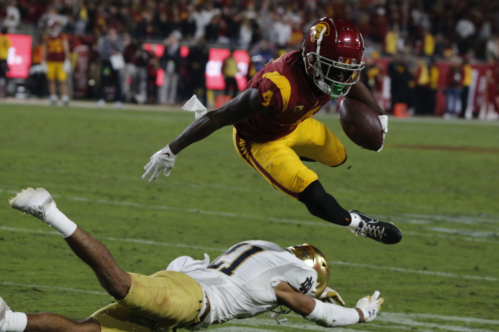 USC receiver Mario Williams hurdles over Notre Dame cornerback Jaden Mickey after making a catch in the third quarter.