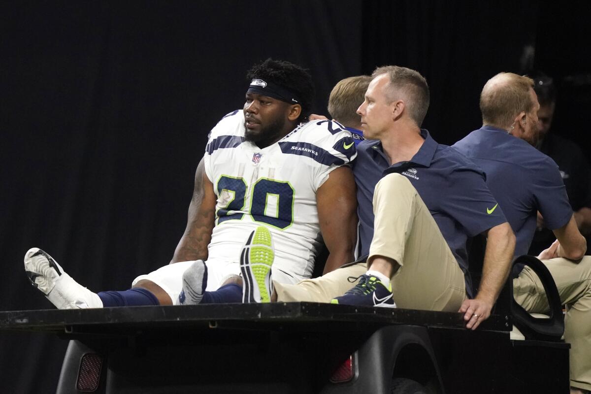 Seattle Seahawks running back Rashaad Penny is carted off the field during an NFL football game against the New Orleans Saints in New Orleans, Sunday, Oct. 9, 2022. (AP Photo/Gerald Herbert)