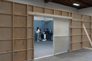 Elaine Batchlor sorts screws and bolts with a robot in a mockup at Encord.
