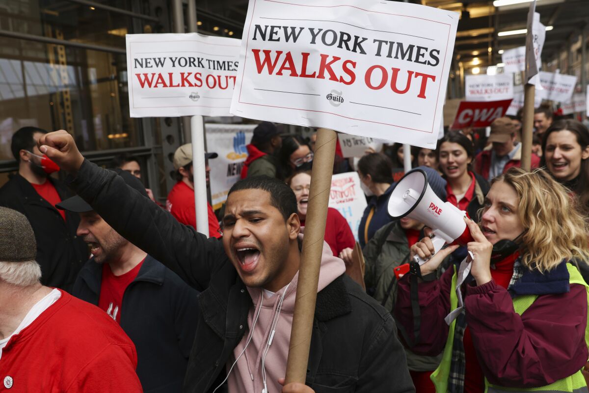 Hundreds of New York Times journalists and other employees demonstrate outside the Times offices after leaving their jobs