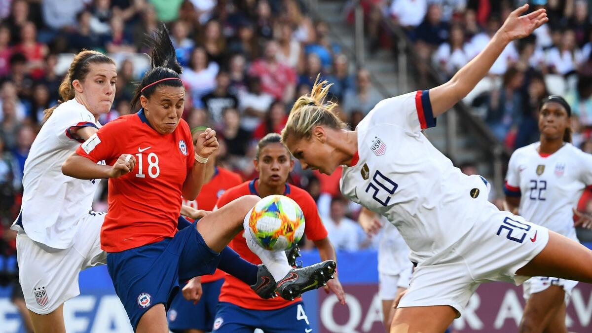 U.S. midfielder Allie Long, right, and Chile defender Camila Saez vie for the ball during a Women's World Cup match June 16 in Paris.