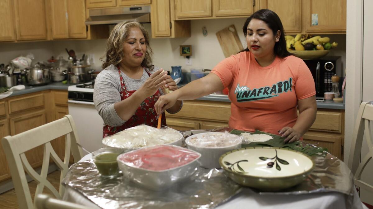 Gabriela Cruz, right, and her mother, Irma Cruz, make tamales at their home in Santa Cruz.
