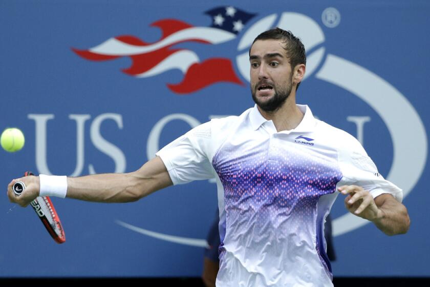 Marin Cilic returns a shot to Jo-Wilfried Tsonga during a quarterfinal match at the U.S. Open on Tuesday.