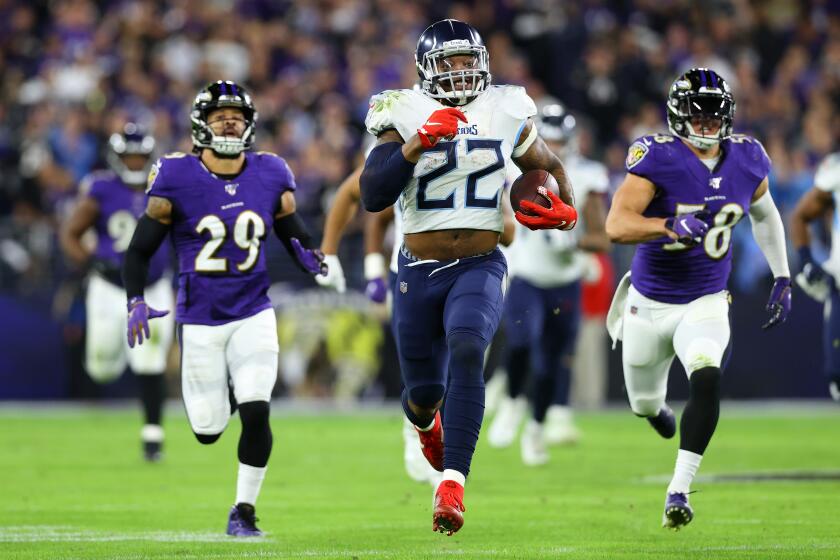 BALTIMORE, MARYLAND - JANUARY 11: Running back Derrick Henry #22 of the Tennessee Titans carries the ball against the Baltimore Ravens during the AFC Divisional Playoff game at M&T Bank Stadium on January 11, 2020 in Baltimore, Maryland. (Photo by Rob Carr/Getty Images)