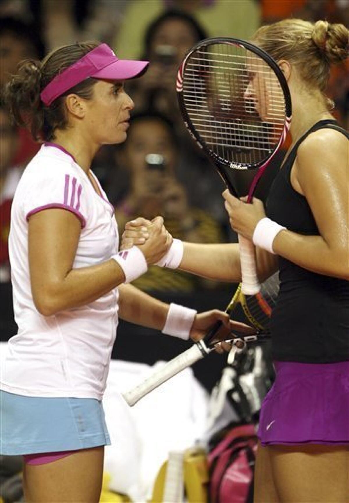 Anabel Medina Garrigues of Spain, left, shakes hands Sabine Lisicki of Germany after their semifinal tennis match at the Bali Tournament of Champions tennis match in Nusa Dua, Bali, Indonesia, Saturday, Nov. 5, 2011. Medina Garrigues won the match as Lisicky retired with a back injury. (AP Photo/Firdia Lisnawati)