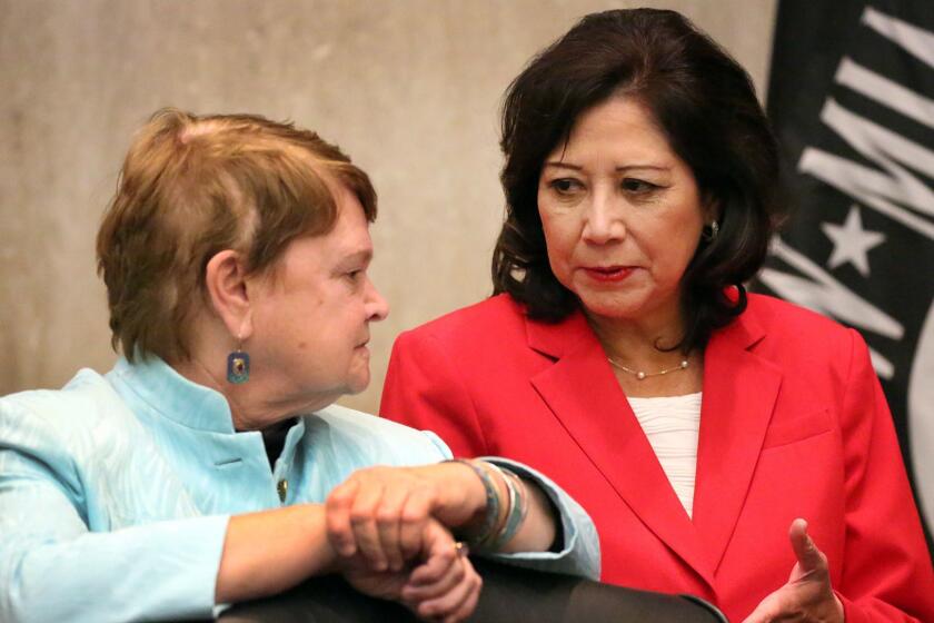 LOS ANGELES, CA - DECEMBER 08, 2015 - On her first day as Chairman, Los Angeles County Supervisor Hilda L. Solis, right, talks to Supervisor Sheila Kuehl, left, Tuesday, December 08, 2015. The supervisors are set to vote voicing their willingness to welcome Syrian refugees and to send a letter to President Barack Obama and the county's congressional delegation "expressing the Board's support of federal efforts to help Syrians fleeing violence and oppression and to increase the overall number of refugees that the U.S. will resettle over the course of the next two years. Antonovich drew fire from the local Muslim community for declaring that when he heard about the mass shooting in San Bernardino, "The first thing I asked about this incident, was the guy named Muhammad." (Al Seib / Los Angeles Times)
