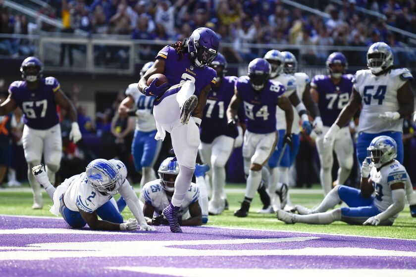 Minnesota Vikings running back Alexander Mattison, center, celebrates after scoring on a 6-yard touchdown run during the second half of an NFL football game against the Detroit Lions, Sunday, Sept. 25, 2022, in Minneapolis. (AP Photo/Craig Lassig)