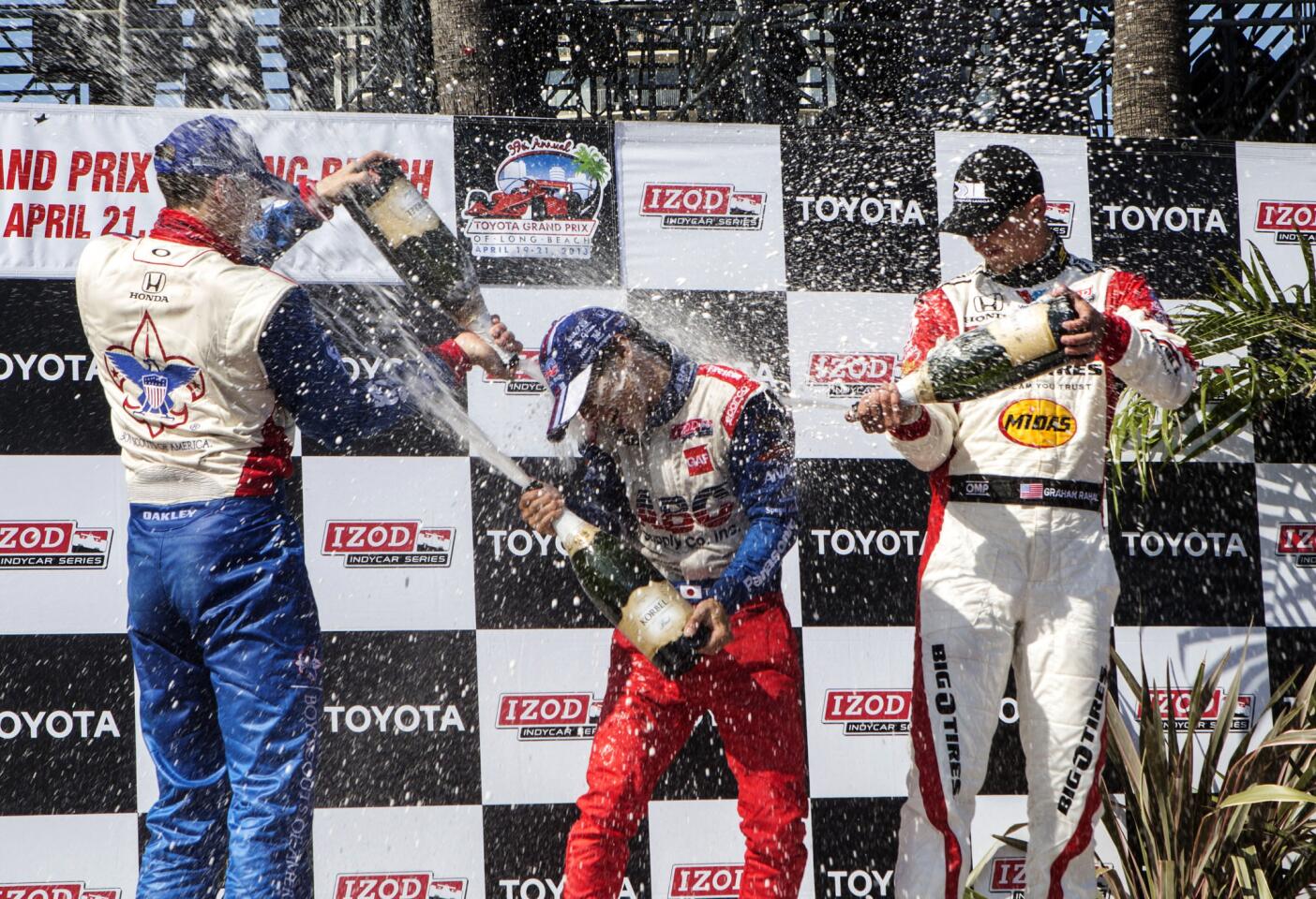 From left, Justin Wilson, Takuma Sato, and Graham Rahal celebrate on the podium after the IndyCar Series Grand Prix of Long Beach auto race.