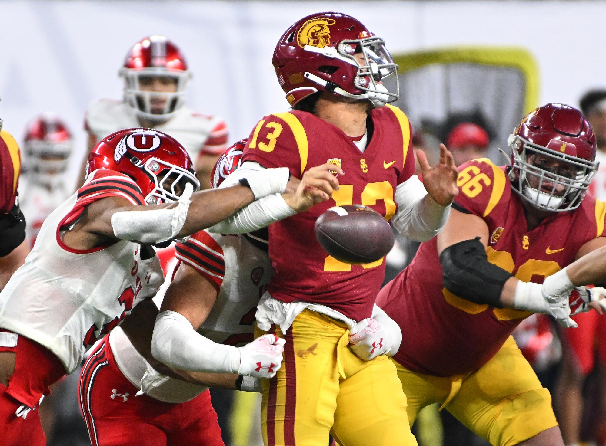 Utah linebacker Mohamoud Diabate, left, forces USC quarterback Caleb Williams to fumble the ball.