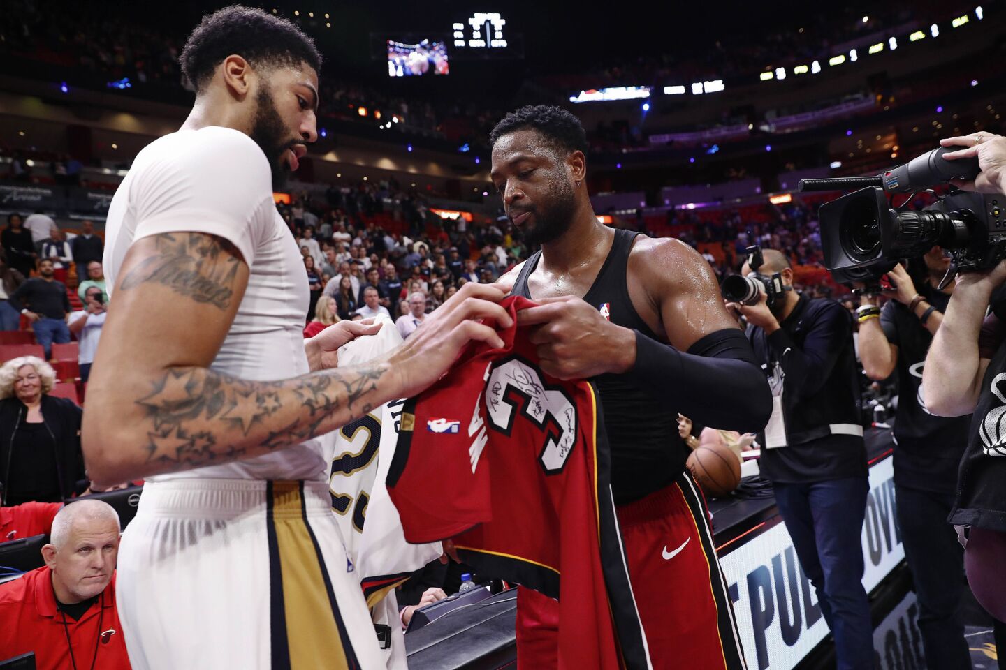 Pelicans forward Anthony Davis and Miami Heat guard Dwyane Wade trade jerseys after a game Nov. 30, 2018, in Miami.