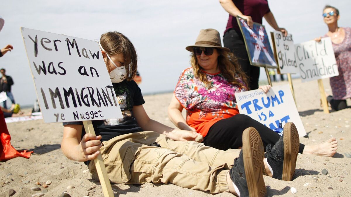 Protesters on a beach near Turnberry golf club, Scotland, on July 14, 2018.