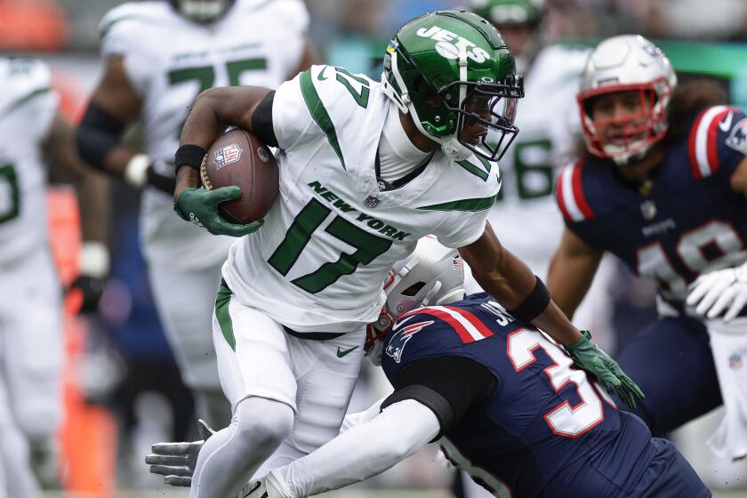 New York Jets wide receiver Garrett Wilson (17) is tackled by New England Patriots linebacker Anfernee Jennings (33) during the first quarter of an NFL football game, Sunday, Sept. 24, 2023, in East Rutherford, N.J. (AP Photo/Adam Hunger)