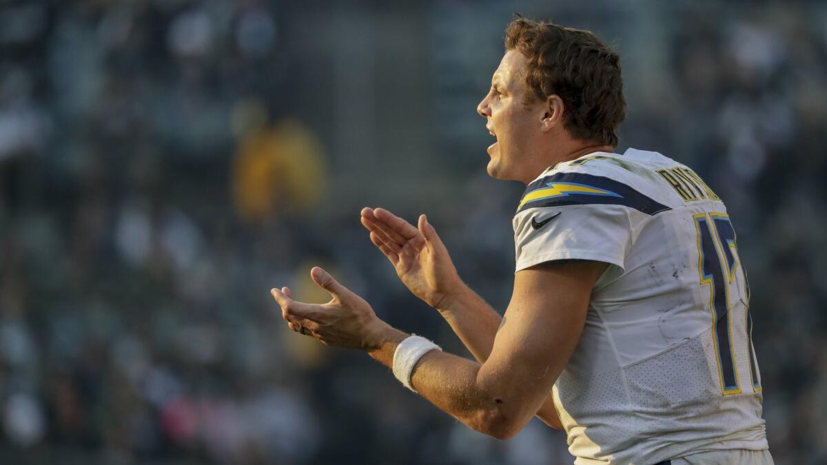 Chargers quarterback Philip Rivers yells out to defensive players from the sidelines late in the game against the Raiders at Oakland-Alameda County Coliseum on Nov. 11, 2018.