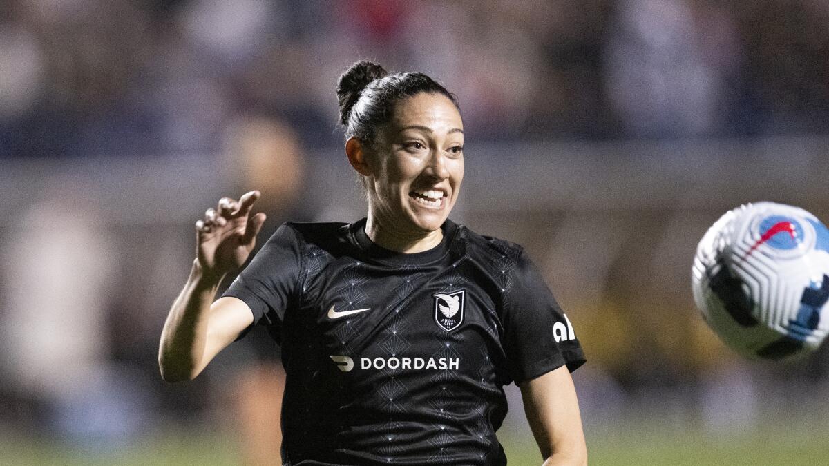Angel City FC forward Christen Press chases a ball against San Diego during the 2022 season