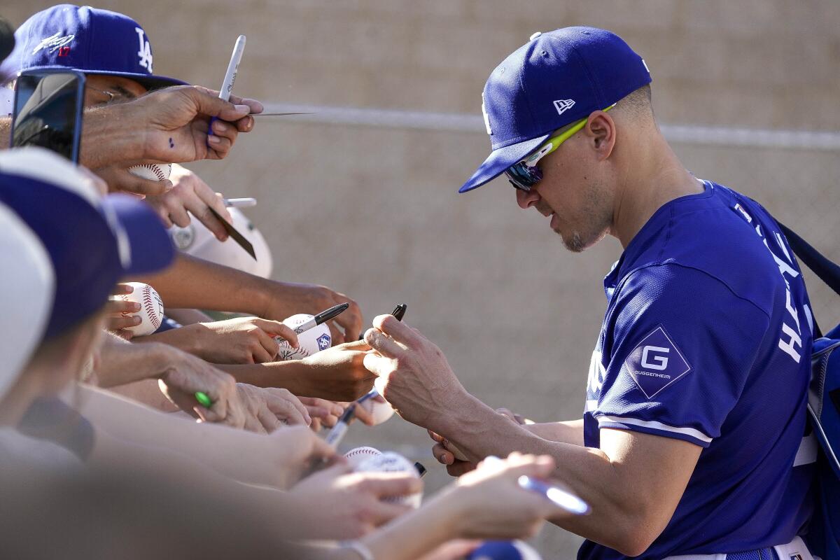 Dodgers infielder Kiké Hernández signs autographs during spring training at Camelback Ranch on Thursday.