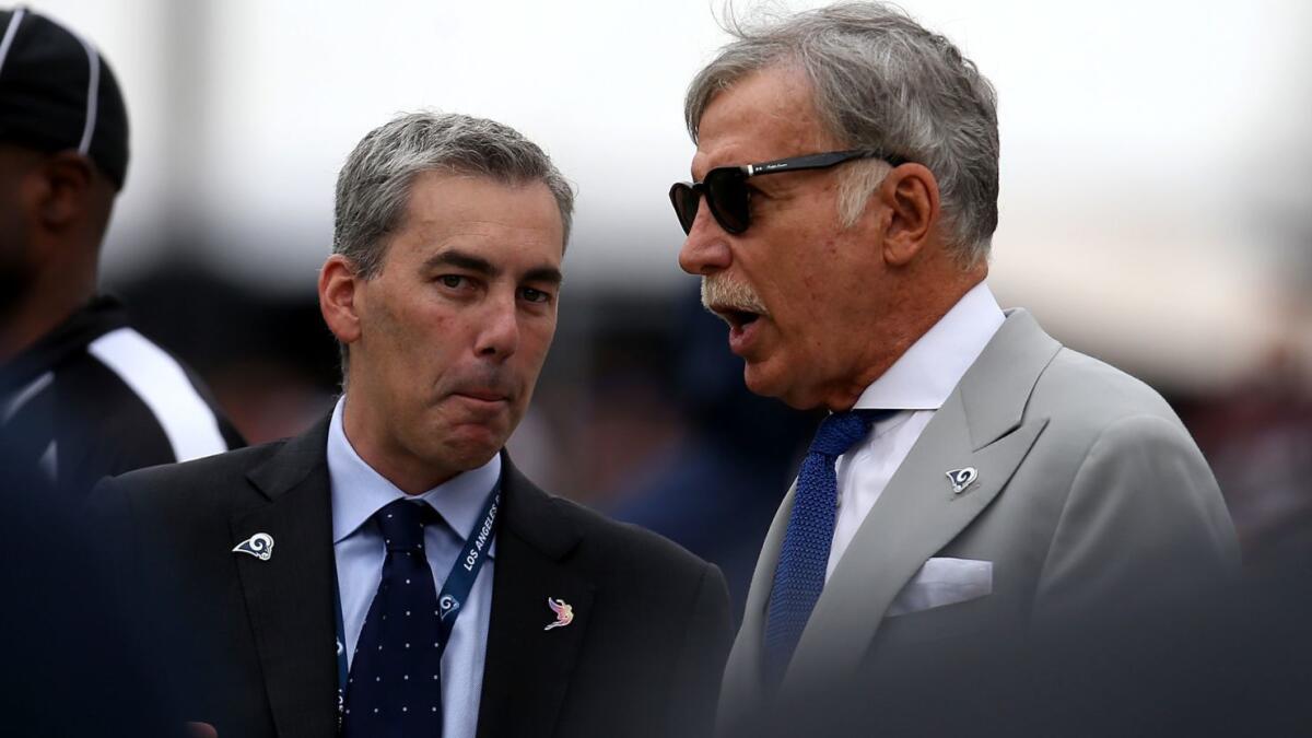 Rams owner Stan Kroenke, right, talks to chief executive Kevin Demoff along the sideline during a game against the Redskins last season at the Coliseum.